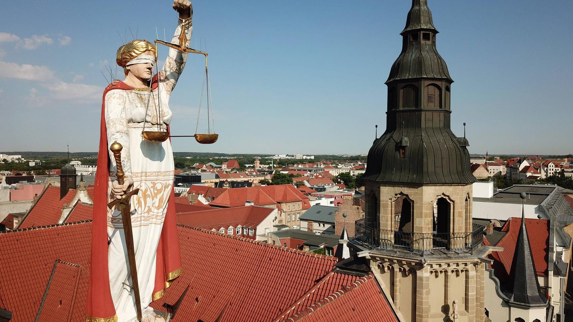 Justitia auf dem Dach des Landgerichts Halle an der Saale (Symbolbild): Ein Tatverdächtiger schweigt bislang zu einer gewalttätigen Attacke mit einer Axt.