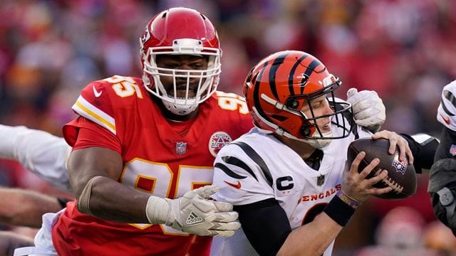 Cincinnati Bengals-Quarterback Joe Burrow (9) durchbricht einen Tackle-Versuch von Kansas City Chiefs-Defensive End Chris Jones (95) während der zweiten Halbzeit.