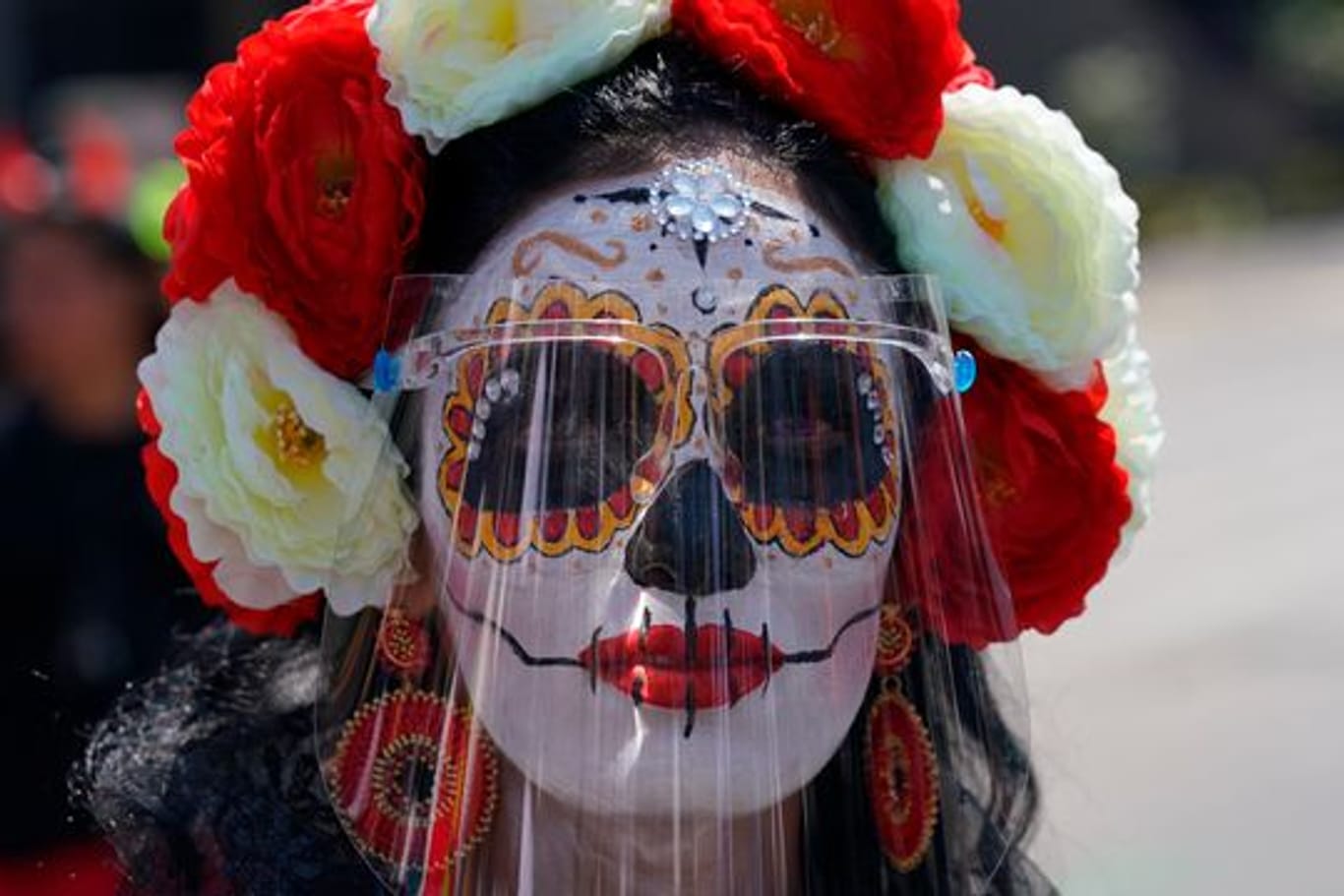 Eine als "Catrina" verkleidete Frau trägt während der Feierlichkeiten zum Tag der Toten ein Gesichtsschild.