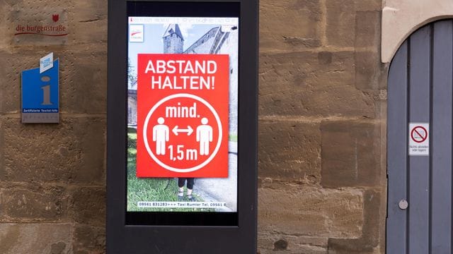 In der Coburger Innenstadt weist eine Tafel darauf hin, den Mindestabstand von 1,5 Metern aufgrund der Corona-Bedingungen einzuhalten. In der Coburger Innenstadt weist eine Tafel darauf hin, den Mindestabstand von 1,5 Metern aufgrund der Corona-Bedingungen einzuhalten.