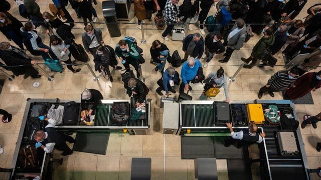 Passagiere an einer Sicherheitskontrolle des Flughafen BER.