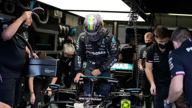 Der britische Mercedes-Pilot Lewis Hamilton steigt in seinen Rennwagen.