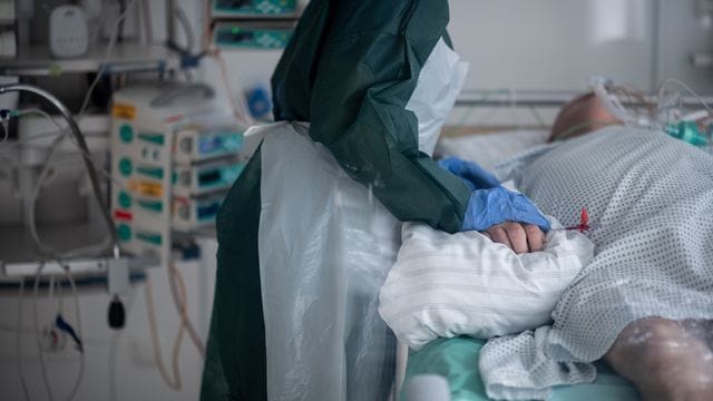 Eine Mitarbeiterin der Pflege betreut einen Covid-Patienten im nordrhein-westfälischen Essen. Eine Mitarbeiterin der Pflege betreut einen Covid-Patienten im nordrhein-westfälischen Essen.