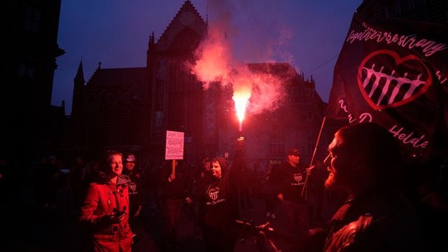 Menschen bei einer Demonstration gegen die Covid-19-Beschränkungen in Amsterdam teil.