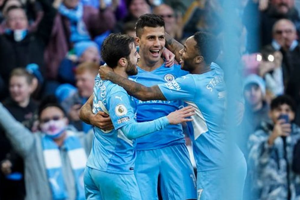 Manchester Citys Rodrigo (M) feiert gemeinsam mit Bernardo Silva und Raheem Sterling (r) das 2:0 für ihr Team.