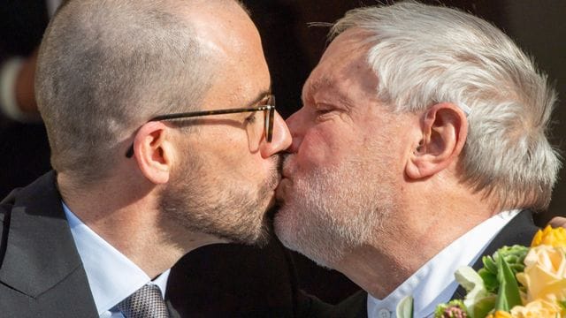 Der ehemalige Benediktiner-Mönch Anselm Bilgri (r) und sein Mann Markus küssen sich nach ihrer Trauung vor dem Münchner Standesamt in der Mandlstraße. Der ehemalige Benediktiner-Mönch Anselm Bilgri (r) und sein Mann Markus küssen sich nach ihrer Trauung vor dem Münchner Standesamt in der Mandlstraße.