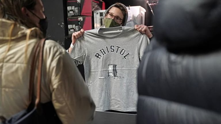 Kunden interessieren sich in einem Geschäft in Bristol für das von Banksy entworfene T-Shirt.