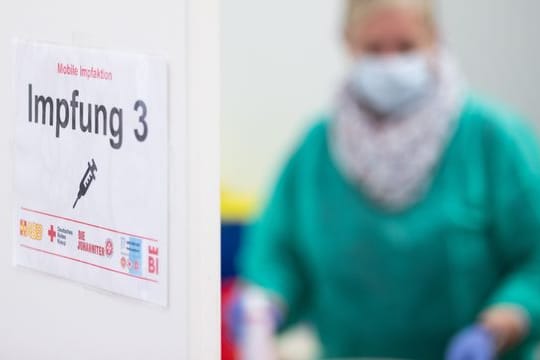 Ein Schild "Impfung 3" an einer Impfstation in Bielefeld.