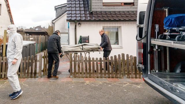 Bestatter bringen eine Trage mit einem Leichnam aus dem Wohnhaus in Glinde.