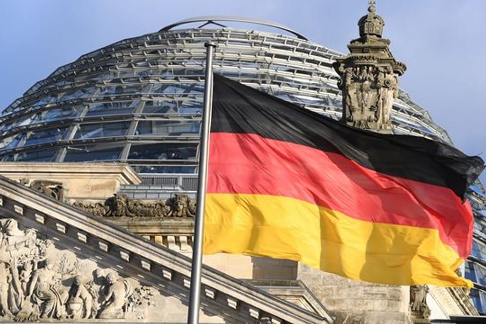 Die schwarz-rot-goldene Flagge vor der Kuppel des Reichstages.