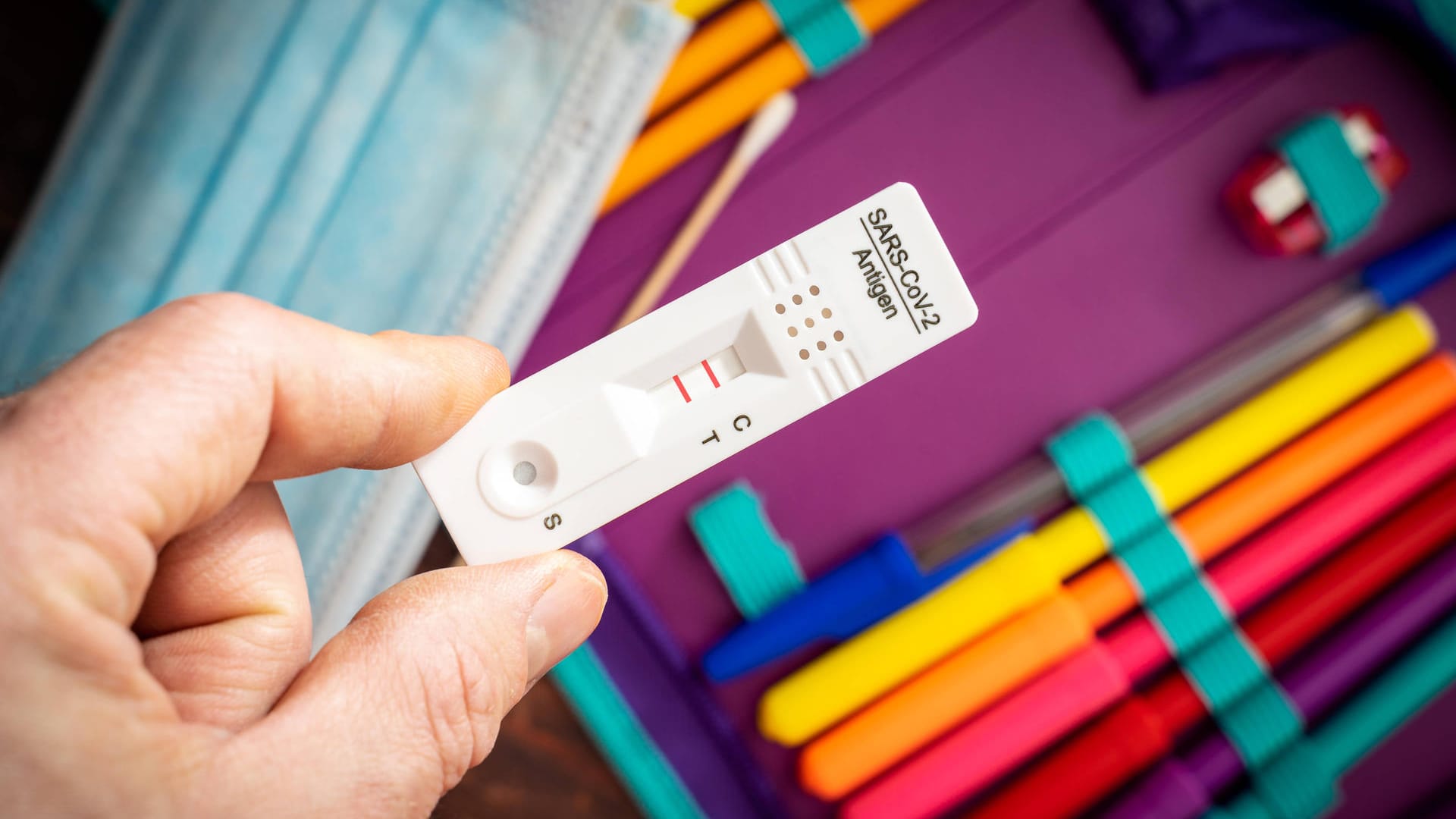 Ein positiver Corona-Test über eine Stifte-Mappe (Symbolbild): Verdi München warnt, dass Corona-Regeln die Kita-Mitarbeiter überlasten könnten. Ein positiver Corona-Test über eine Stifte-Mappe (Symbolbild): Verdi München warnt, dass Corona-Regeln die Kita-Mitarbeiter überlasten könnten.
