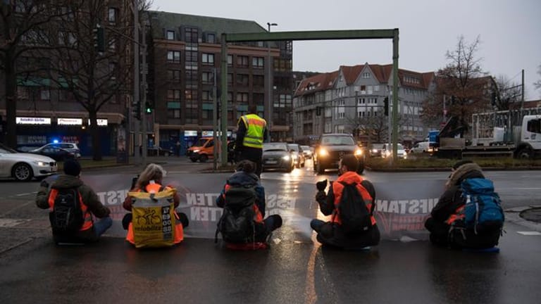 Aktivisten einer Gruppe, die sich "Aufstand der letzten Generation" nennt, blockieren in Berlin-Steglitz die Autobahn-Zufahrt.