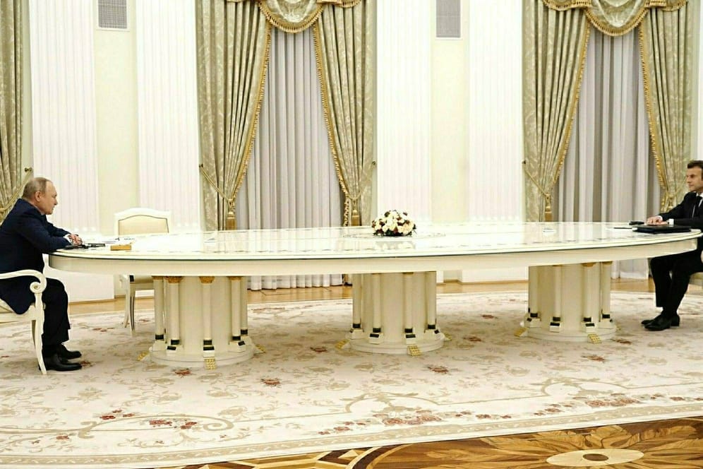 Putin und Macron: Die beiden saßen sich an einem langen Tisch gegenüber.