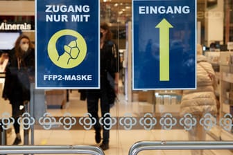 Hinweisschilder in einem Hamburger Geschäft (Symbolbild): Trotz Beschränkungen ist die Inzidenz in Deutschland noch hoch.