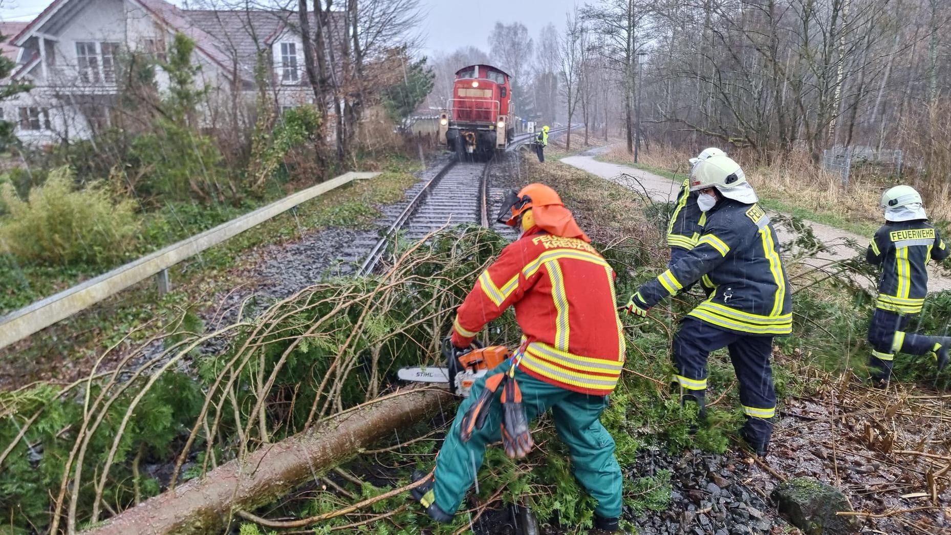 Nordrhein-Westfalen, Kreuztal: Einsatzkräfte der Feuerwehr räumen einen umgestürzten Baum vom Gleis. Nordrhein-Westfalen, Kreuztal: Einsatzkräfte der Feuerwehr räumen einen umgestürzten Baum vom Gleis.