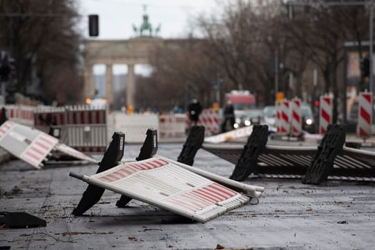 Vom Wind umgerissene Absperrungen liegen an einer Baustelle