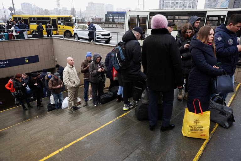 People wait at a bus station in Kyiv after Russian President Vladimir Putin authorized a military operation in eastern Ukraine