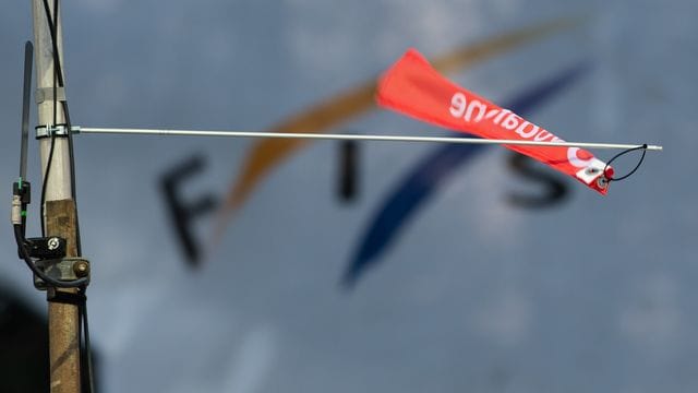 Ein Windfähnchen wehrt vor dem Logo der Fédération Internatonale de Ski (Fis). Ein Windfähnchen wehrt vor dem Logo der Fédération Internatonale de Ski (Fis).
