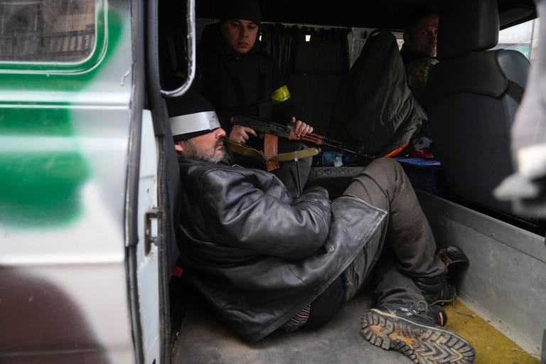 Ukrainische Soldaten halten in Kiew einen Mann fest, den sie für einen russischen Agenten halten.