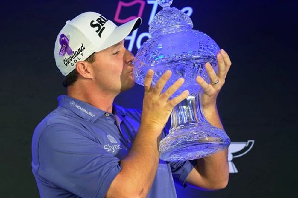 Hat als erster österreichischer Golf-Profi ein Turnier auf der PGA-Tour gewonnen: Sepp Straka feiert seinen Sieg und küsst die Trophäe.