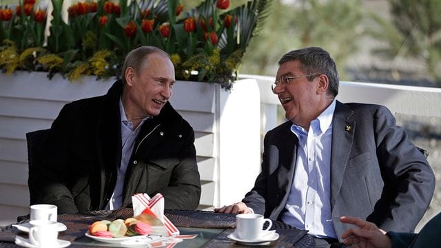 Der russische Präsident Wladimir Putin (l) und der IOC-Präsident Thomas Bach unterhalten sich in einem Cafe an der Promenade am schwarzen Meer während der Olympischen Spiele 2014 in Sotschi. Der russische Präsident Wladimir Putin (l) und der IOC-Präsident Thomas Bach unterhalten sich in einem Cafe an der Promenade am schwarzen Meer während der Olympischen Spiele 2014 in Sotschi.