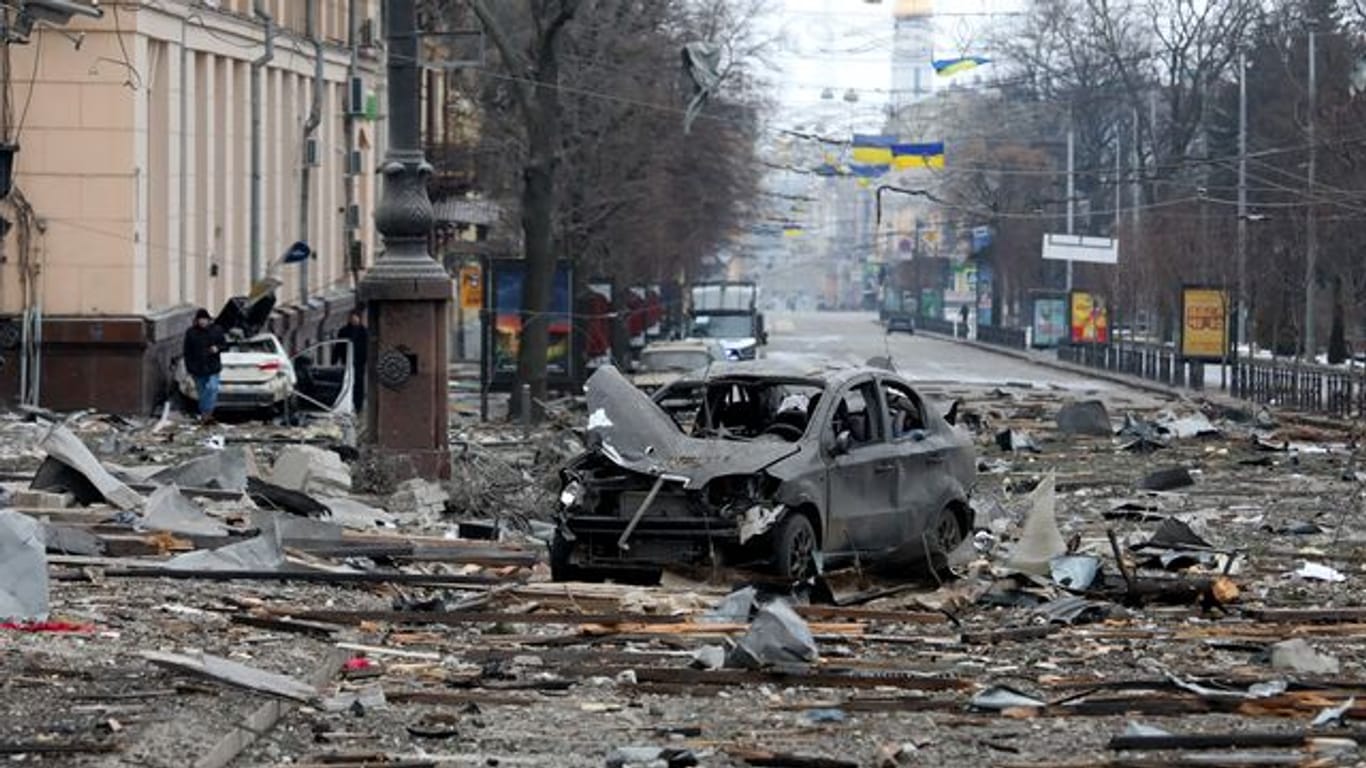Ein ausgebranntes Autos in der Nähe des durch Angriffe zerstörten Gebäudes der regionalen Verwaltung von Charkiw.