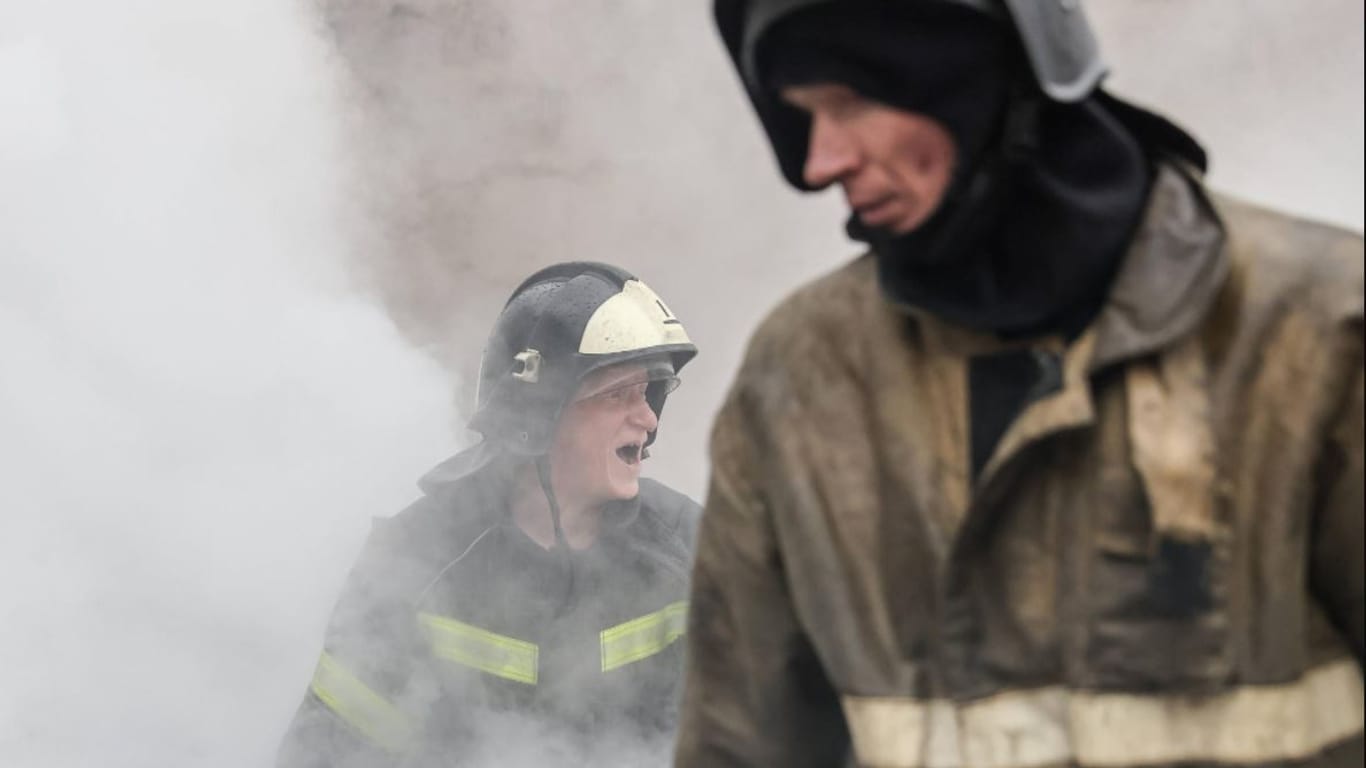 Feuerwehrmänner nach einem Raketeneinschlag im ostukrainischen Donezk.