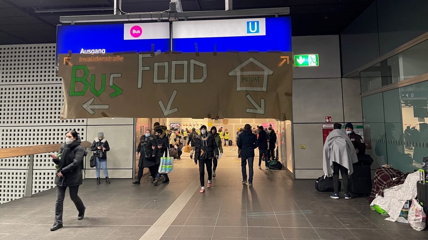 Selbstgebastelte Wegweiser am Berliner Hauptbahnhof zeigen Geflüchteten, wo sie hinmüssen: "Wir stemmen die Ankunft der Personen aus der Ukraine dank der vielen zivilen Freiwilligen"
