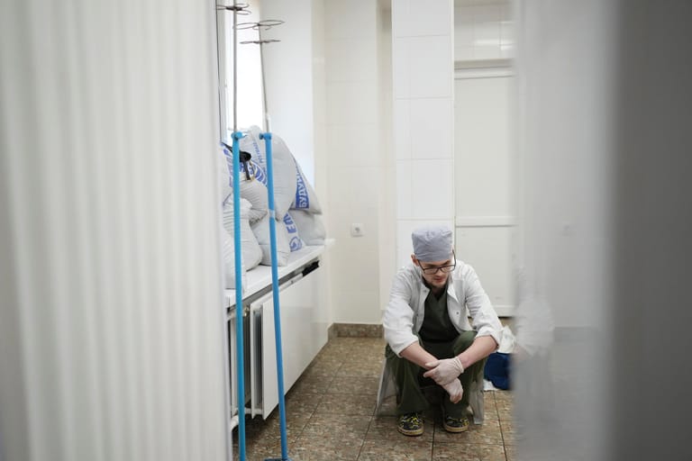 Ein Mitarbeiter im Krankenhauses Mariupol sitzt niedergeschlagen am Boden, nachdem der 18 Monate alte Kirill Yatskos aufhörte zu atmen.