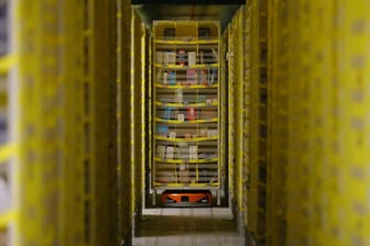 A robotic platform carries a rack by a storage area at Amazon distribution center in El Prat de Llobregat