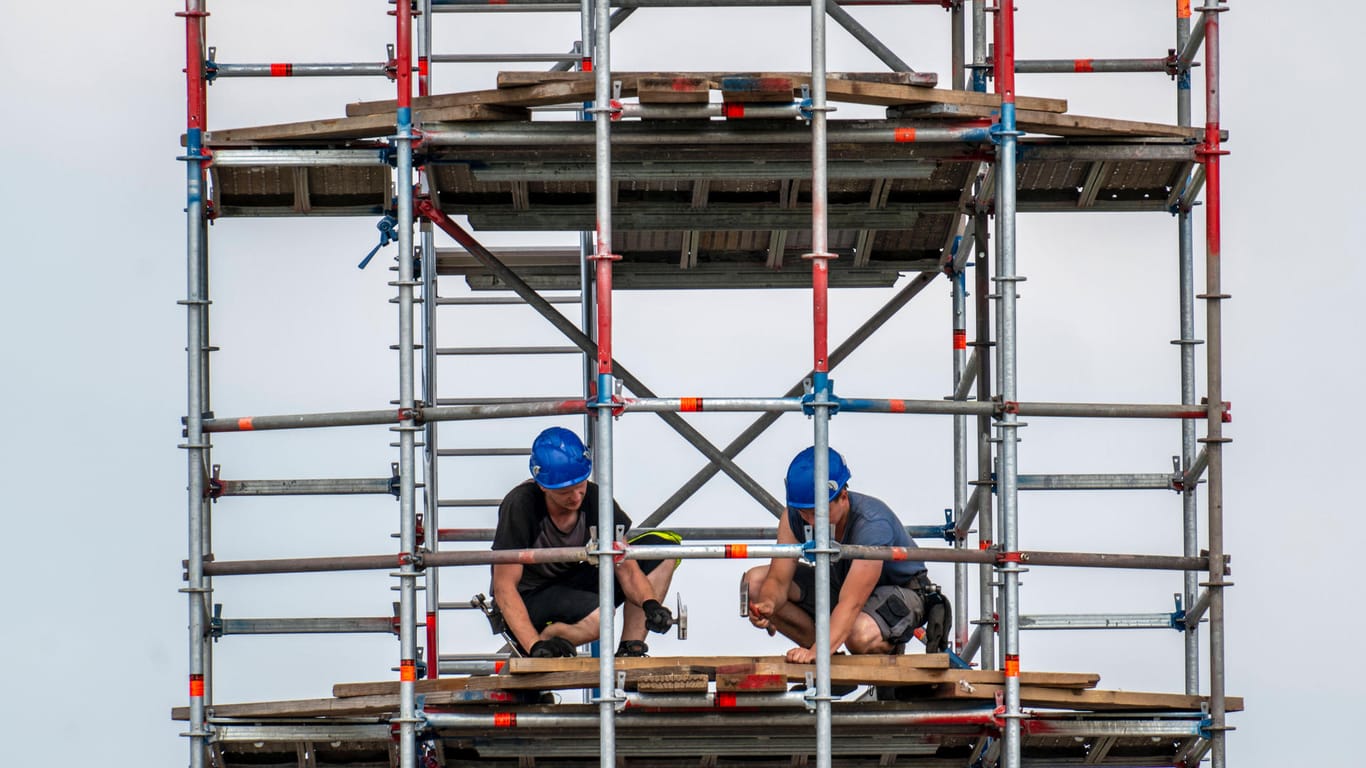 Arbeiter auf einem Baugerüst auf einer Baustelle in Deutschland (Symboldbild): Bei einer Razzia in mehreren Städten wurde ein Schwarzgeldnetzwerk unter Bauunternehmern entlarvt.