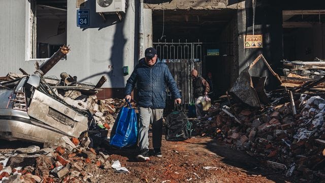 Kaum noch was übrig: Ein Mann trägt seine Habseligkeiten aus seinem zerstörten Haus in Charkow.