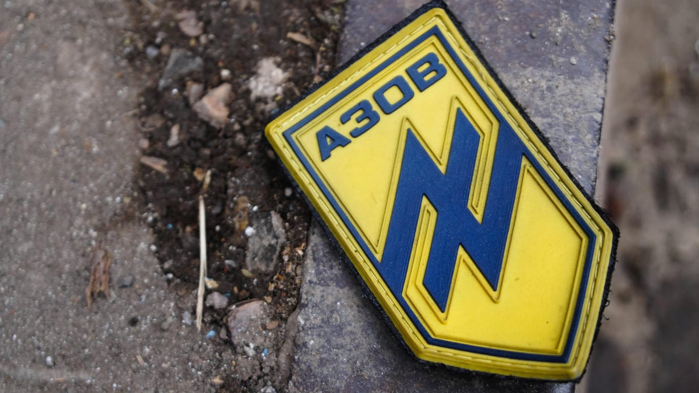 Auf einer Straße in Mariupol liegt ein Abzeichen mit dem Logo des "Asow"-Bataillons.