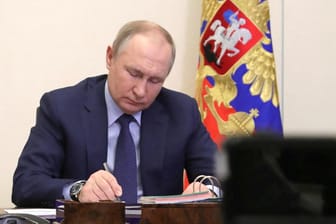 Wladimir Putin macht sich Notizen (Archivbild): Großbritannien will den Druck auf ihn erhöhen.