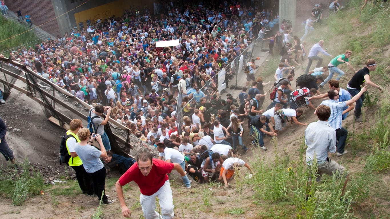 Tausende Raver drängen sich am 24. Juli 2010 auf der Duisburger Loveparade in und vor dem Tunnel, in dem sich eine Massenpanik ereignet hat: Eine Kommission hat das Ereignis aufgearbeitet.