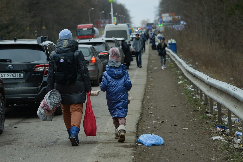 Menschen aus der Ukraine kurz vor der polnischen Grenze: Seit Wochen bringen Busse und Lastwagen Güter in das kriegsgebeutelte Land – und Geflüchtete nach draußen.