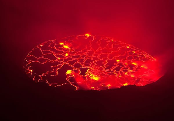 Auf dem Gipfel des Vulkans Nyiragongo im Kongo (Nachtaufnahme): Ein Lavasee schwappt im Krater des Vulkans. Sein Pegel steigt.