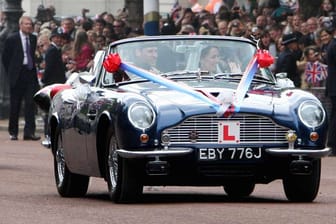 In dem umgerüsteten Aston Martin von Prinz Charles fuhren Prinz William und Frau Catherine zur Prachtstraße The Mall.