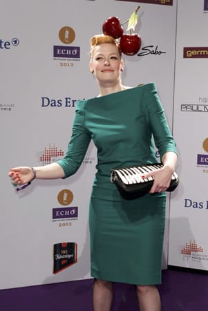 Moderatorin Enie van de Meiklokjes liebt es kitschig-verspielt: Sie erschien im moosgrünen Kleid mit Kirschen auf dem Kopf und Klaviertasche in der Hand.