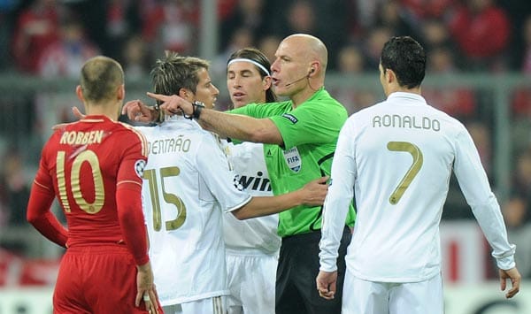 Schiedsrichter Howard Webb (grünes Trikot) aus England weist Fabio Coentrao von Real Madrid zurecht.