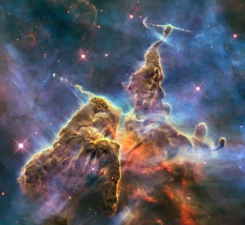 Fantastische Galaxien: Dieses bizarre Gebilde befindet sich im Karina-Nebel. Das Hubble-Weltraumteleskop hält auf dieser Aufnahme die Aktivität einer drei Lichtjahre großen Säule aus Gas und Staub fest. Sie wird gleichzeitig vom funkelnden Licht naher Sterne und von innen von neugeborenen Sternen zerrissen.