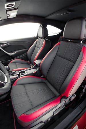 Im Innenraum sind Stoff- und Lederbezüge in Schwarz kombiniert mit roten Akzenten an den Sitzrändern.