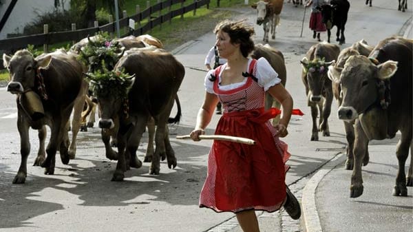 Eine Frau im typischen, knielangem, rot-weiß karierten Dirndl