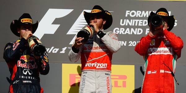 Rennfahren scheint sehr durstig zu machen. Sieger Hamilton (Mi.), Zweitplatzierter Vettel (li.) und der Dritte Alonso nehmen einen ordentlichen Schluck aus der Champagner-Flasche.