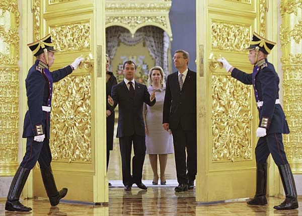 Erst einmal im Amt, reist das Ehepaar durch die Welt und wird von den Staatschefs der Länder - wie hier von Dmitri Medwedew in Russland - mit Prunk und Zeremonien empfangen.