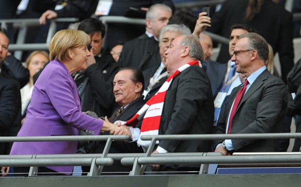Hoher Besuch: Bevor Kanzlerin Angela Merkel auf der Tribüne Platz nimmt, begrüßt sie den Bayern-Vorstand um Uli Hoeneß und Karl-Heinz Rummenigge.