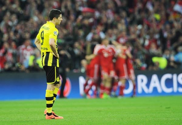 Während die Bayern im Hintergrund jubeln, ist Robert Lewandowski ganz alleine mit seinen Gedanken.