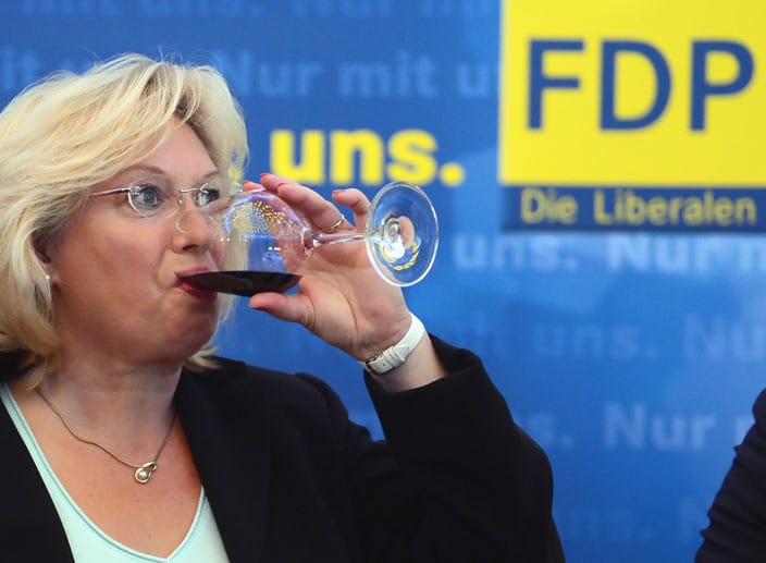 Einen großer Schluck zum Trost: FDP-Anhängerin in Berlin