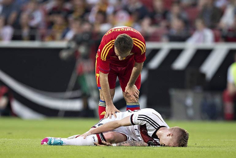 Am Boden zerstört: Marco Reus liegt mit schmerzverzerrtem Gesicht auf dem Rasen der Mainzer Arena. Gegenspieler Artur Yedigaryan muss hilflos zusehen.