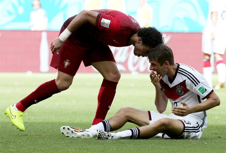 Für Portugal kommt's noch schlimmer: Erst watscht Verteidiger Pepe (li.) seinen Gegenspieler Müller ab, dann legt er mit einem Kopfstoß gegen den am Boden sitzenden Torschützen nach...